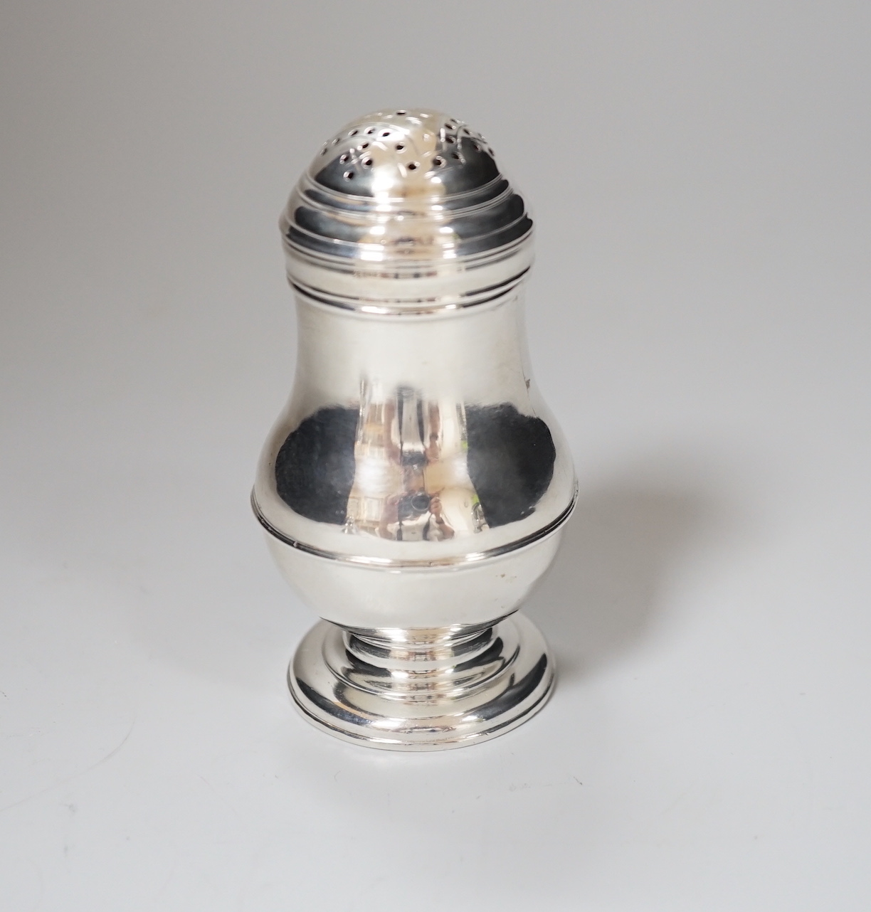 A George I Britannia standard silver baluster muffineer, makers mark rubbed, London 1721, 8.5cm, 72 grams